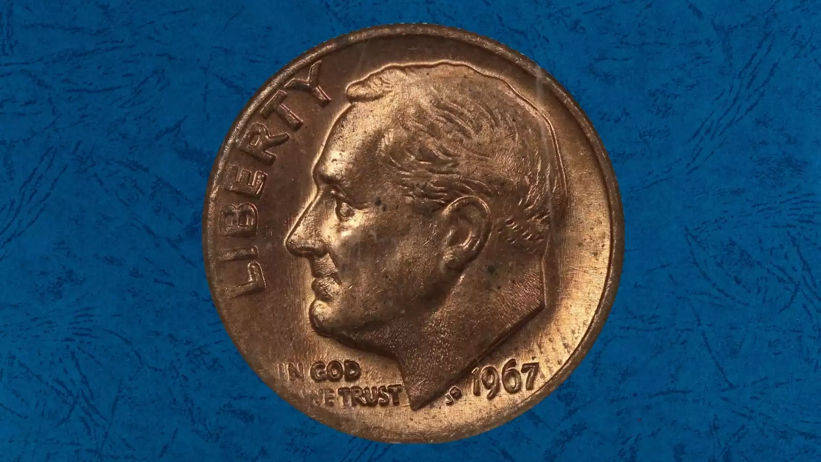 1967 Roosevelt dime missing clad layer error showing copper-colored face versus normal silver clad face